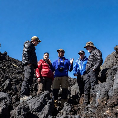 Group hikers on volcanic terrain