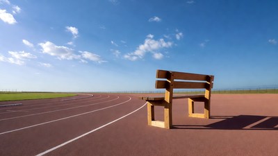Wooden bench on running track