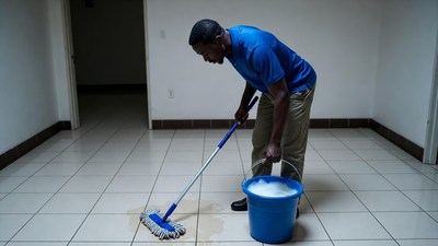 African-American man mopping floor