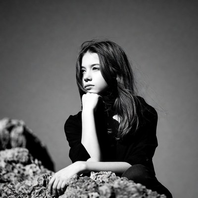 Teen girl thinking on rocks