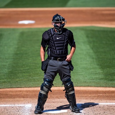 Baseball catcher standing on field