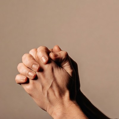 Hands clasped in prayer
