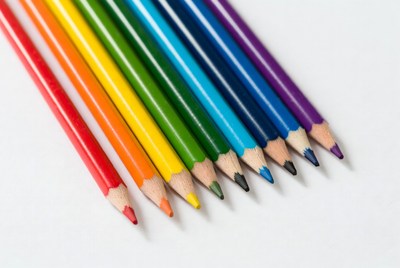 Colorful crayons arranged on white background