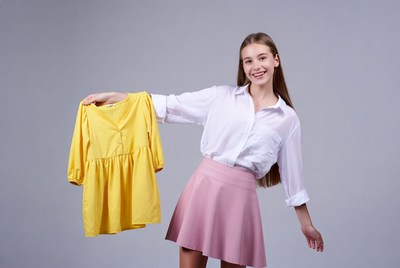 Teen girl holding yellow dress