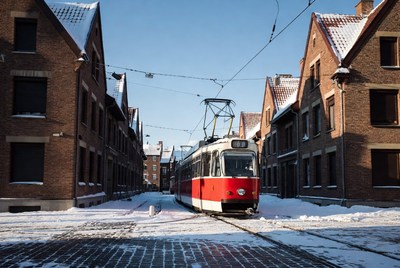Red Tram in Snowy Narrow Street