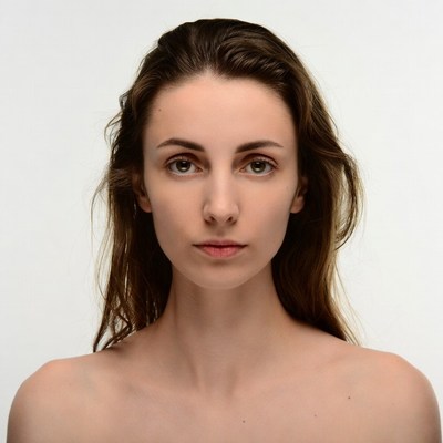 Nude woman with wavy brown hair