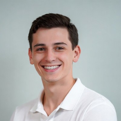 Smiling young man in white polo