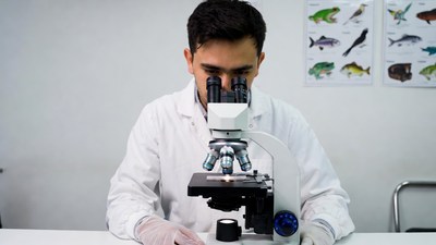Man using microscope in lab