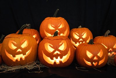 Carved Jack-o-Lantern Pumpkins on Hay