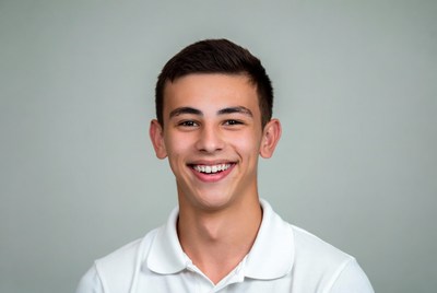 Smiling young man in white polo shirt