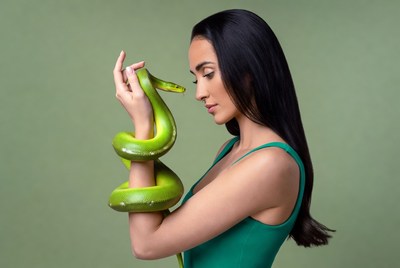 Woman holding green snake