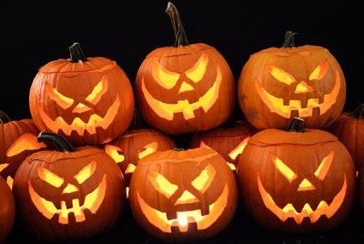 Jack-o'-lantern pumpkins on black background