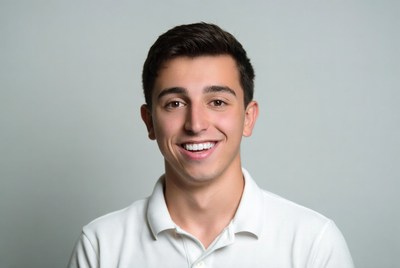 Smiling young man in white polo