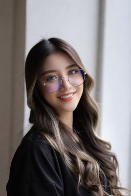 Asian woman smiling with blue light glasses