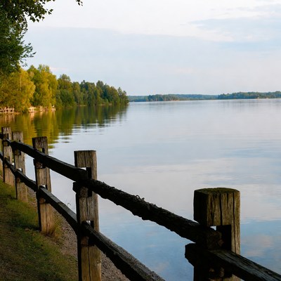 Wooden fence by calm lake