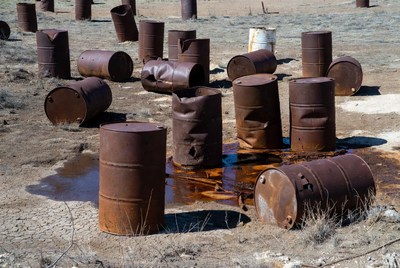 Rusty Oil Drums Scattered in Desert