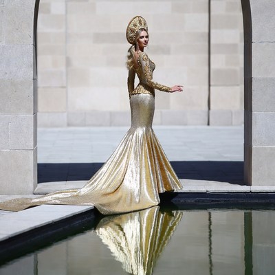 Woman in gold gown with kokoshnik by pool