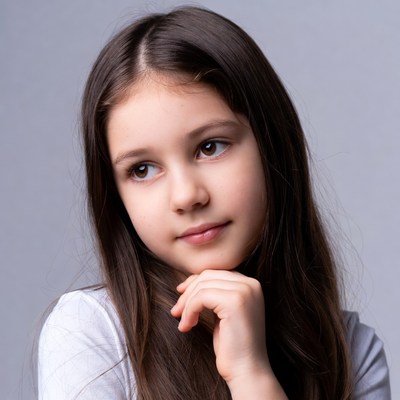 Young girl thinking with hand on chin