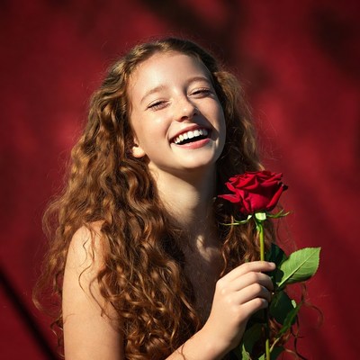 Girl holding red rose