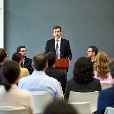 Man speaking at podium to audience