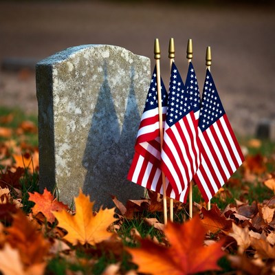 Grave with American Flags in Autumn Leaves