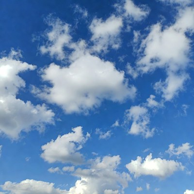 Fluffy white clouds in blue sky