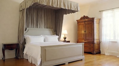 Elegant Four-Poster Bed with Armoire