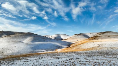 Snowy Hills Under Blue Sky