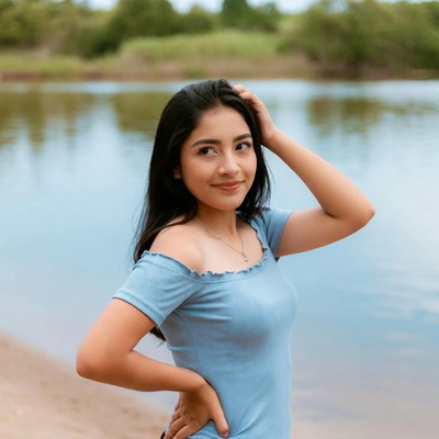 Latina woman posing by lake