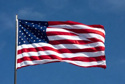 American flag waving against blue sky
