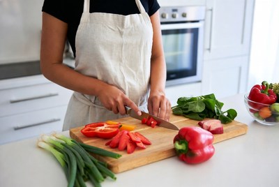 Woman chopping vegetables in kitchen