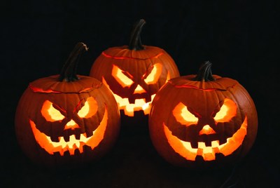 Three Lit Jack-o-Lanterns on Black Background