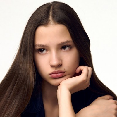 Teen girl with hand on chin