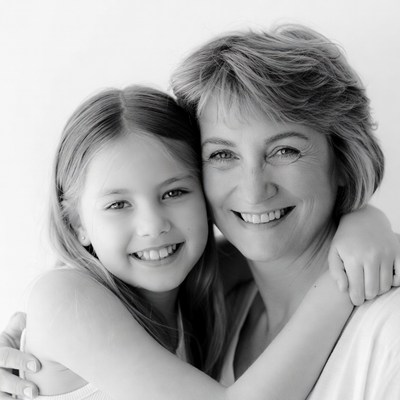 Smiling mother hugging daughter