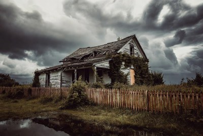 Abandoned house under stormy sky