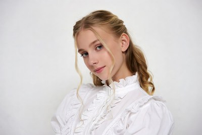 Blonde girl in ruffled white blouse