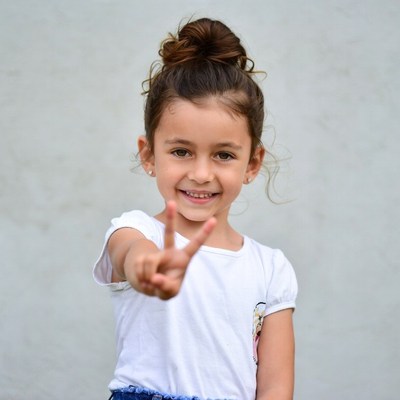 Girl making peace sign