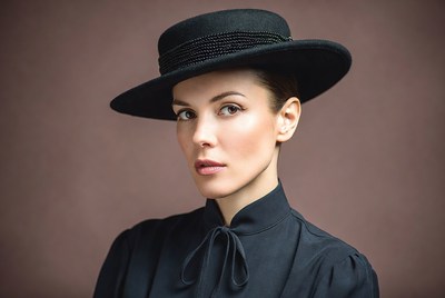 Woman wearing black wide-brim hat