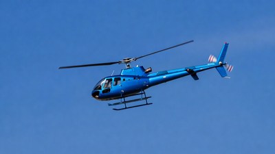Blue Helicopter Flying in Sky