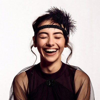 Smiling woman in feathered headband