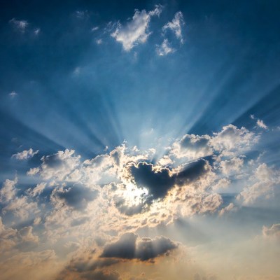 Sun rays beaming through clouds