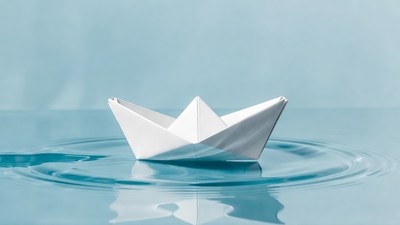 White origami boat on water