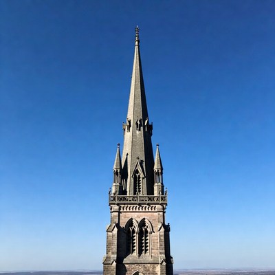 Gothic Church Steeple Against Blue Sky