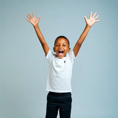 African-American boy raising arms excitedly