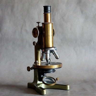 Vintage Brass Microscope on Gray Background