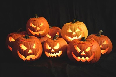 Group of lit jack-o-lantern pumpkins