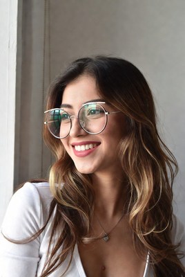 Smiling woman with glasses by window