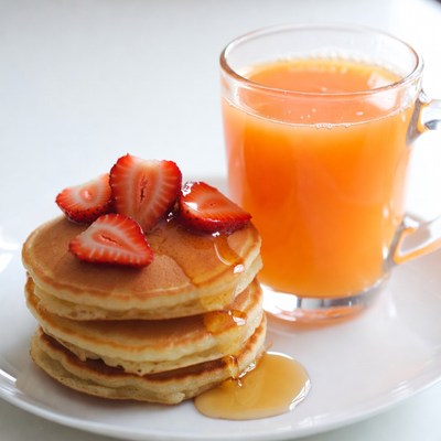 Pancakes with Strawberries and Orange Juice