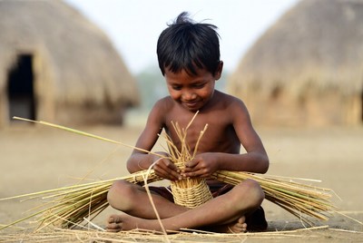 Young Asian boy weaving basket