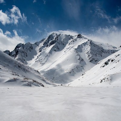 Snowy Mountain Peak Under Blue Sky